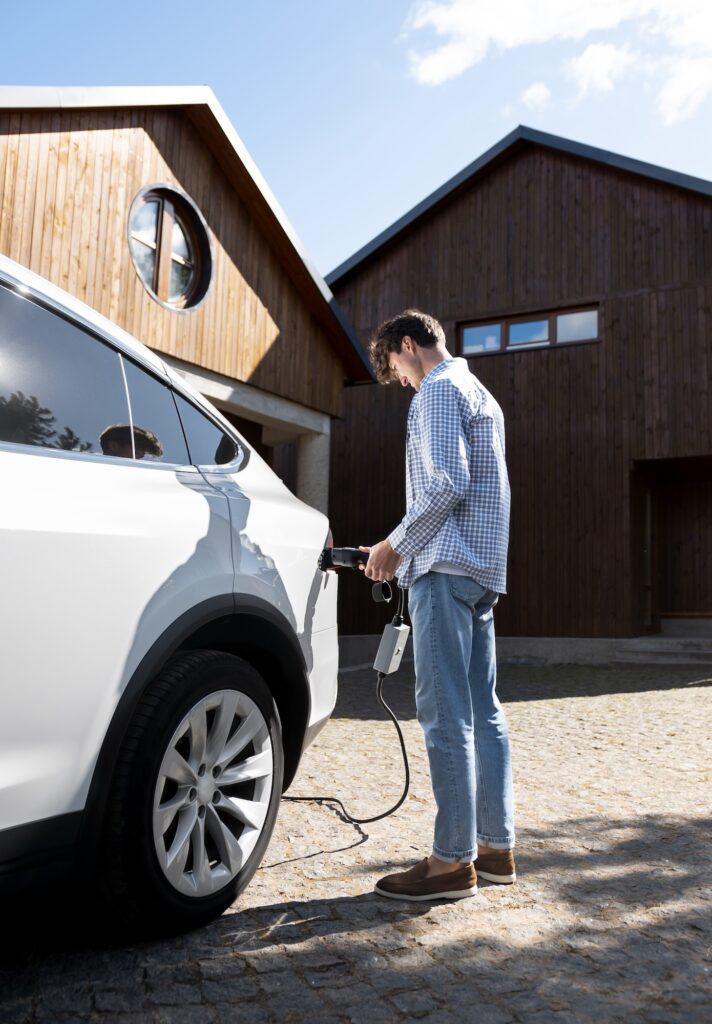 a man holding a car with a hose in front of him